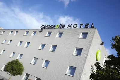 a building with a sign on the top of it at Campanile Hotel & Restaurant Brussels Vilvoorde in Vilvoorde
