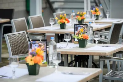 a group of tables with wine glasses and flowers on them at Campanile Hotel & Restaurant Brussels Vilvoorde in Vilvoorde