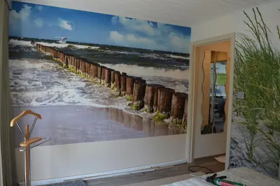 a wall mural of a beach pier at B&B Bij MoeMee in Ghent