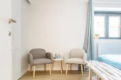 two chairs and a table in a bedroom at B&B Eat&Sleep in Evergem