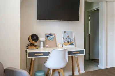 a white desk with a white chair in a room at B&B Eat&Sleep in Evergem