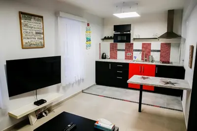 a kitchen with a flat screen tv and a table at Apartment in Antwerp city centre in Antwerp