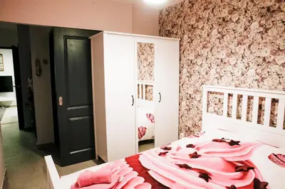 a bedroom with a pink bed with a pink blanket at Apartment in Antwerp city centre in Antwerp