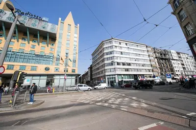 a busy city street with buildings and cars on the road at Apartment in Antwerp city centre in Antwerp
