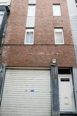 a garage door in front of a brick building at Apartment in Antwerp city centre in Antwerp
