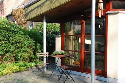 a table and chairs sitting outside of a building at Vakantiestudio 'Kleine Johannes' in Duffel
