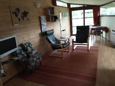 a living room with two chairs and a television at Vakantiestudio 'Kleine Johannes' in Duffel