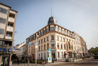 a building with a clock tower on top of it at Hotel De Spiegel in Sint-Niklaas