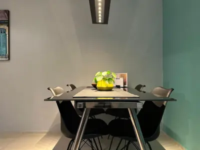 a dining room table with chairs and a plant on it at Sweetwater Privé Wellness in Oud-Heverlee