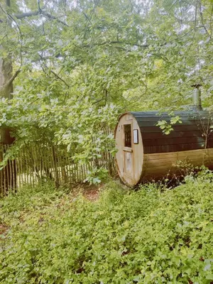 a small wooden cabin in the middle of a field at Sweetwater Privé Wellness in Oud-Heverlee
