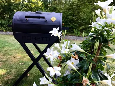 a blue mailbox on a tripod next to flowers at Sweetwater Privé Wellness in Oud-Heverlee
