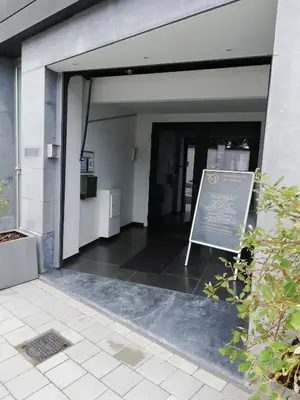 an entrance to a building with a sign in front of it at Touristflat Dewulf in Ghent