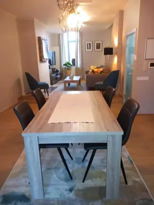 a living room with a table and chairs at Touristflat Dewulf in Ghent