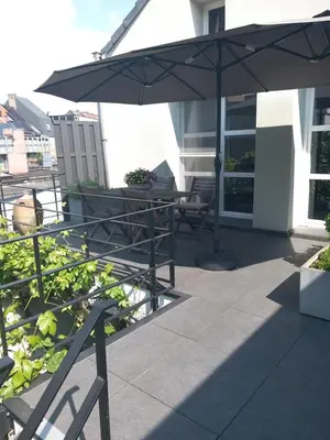 a patio with a table and an umbrella at Touristflat Dewulf in Ghent