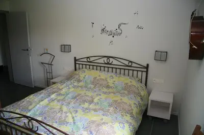 a bedroom with a bed with a comforter on it at B&B Aalsters-genot in Aalst