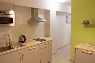 a small kitchen with a sink and a stove at Renovated Apartment in Antwerp city center in Antwerp