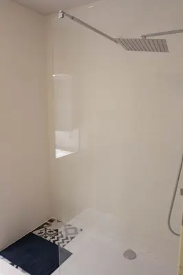 a shower with a glass door in a bathroom at Renovated Apartment in Antwerp city center in Antwerp