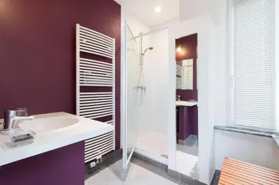 a bathroom with a white sink and a shower at Fantastic Large House in Brussels