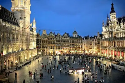 a group of people walking around a city at night at Fantastic Large House in Brussels