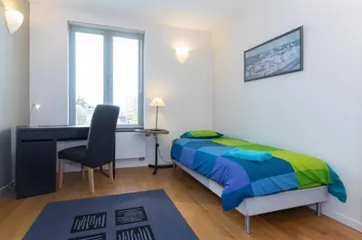 a bedroom with a bed and a desk and a chair at Fantastic Large House in Brussels