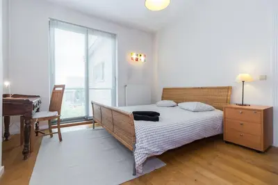 a bedroom with a bed and a desk and a piano at Fantastic Large House in Brussels