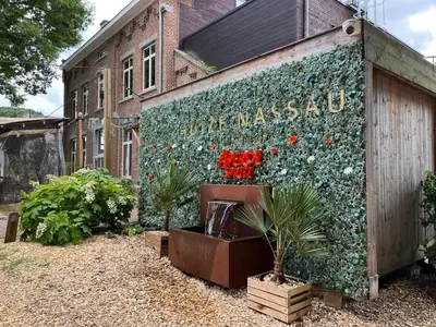 a mural on the side of a building with flowers at Huize Nassau in Zelem
