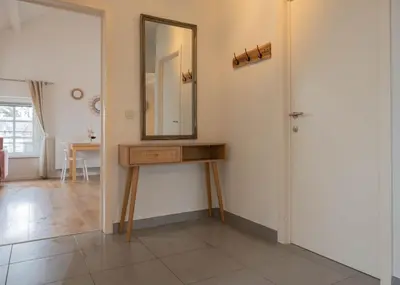 a bathroom with a mirror and a wooden table at Huize Nassau in Zelem