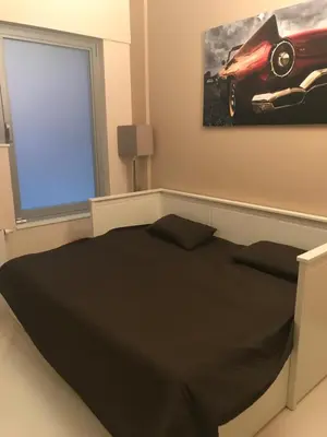 a bedroom with a black bed and a window at Beautiful LOFT in the Center of Brussels in Brussels