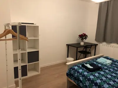 a bedroom with a bed and a book shelf at African heritage Tervuren in Tervuren
