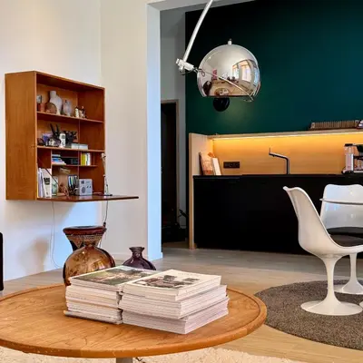 a pile of books on a coffee table in a living room at Great to stay Gent I rooms & apartments in Ghent
