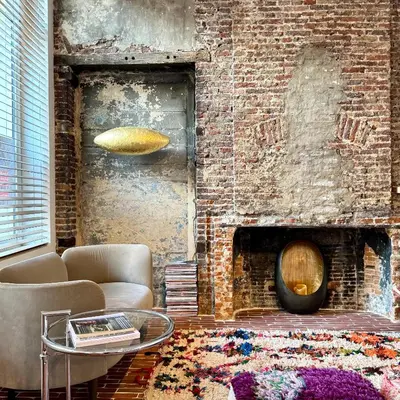 a living room with a couch and a brick wall at Great to stay Gent I rooms & apartments in Ghent