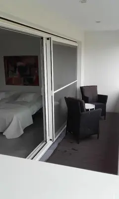 a bedroom with a bed and a chair and a window at B&B Het Museum in Berlaar