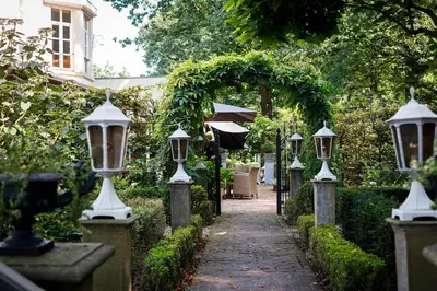 a walkway with a group of lights and an arch at Ter Heide (Kaprijke - Lembeke) in Lembeke