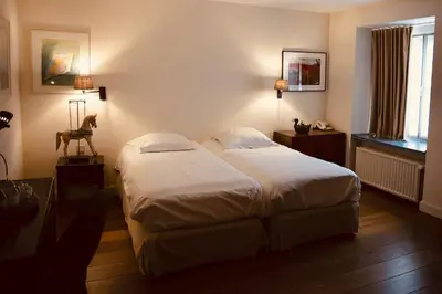 a bedroom with a large bed and a window at Ter Heide (Kaprijke - Lembeke) in Lembeke