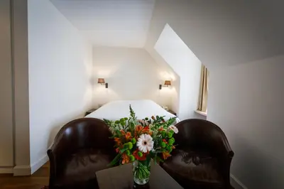 a bedroom with a bed and a vase of flowers at Ter Heide (Kaprijke - Lembeke) in Lembeke
