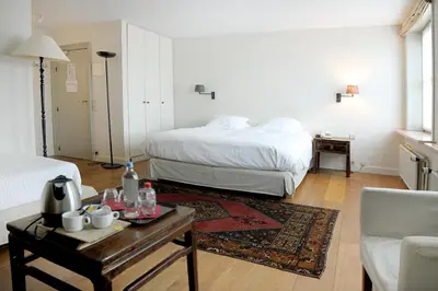 a bedroom with a bed and a coffee table with a coffee maker at Ter Heide (Kaprijke - Lembeke) in Lembeke