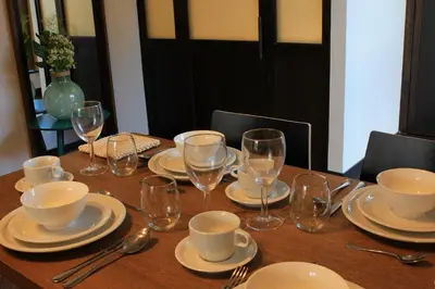 a table with plates and wine glasses on it at Getaway Brussels Airport in Zaventem