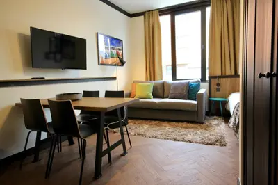 a living room with a table and a couch at Getaway Brussels Airport in Zaventem