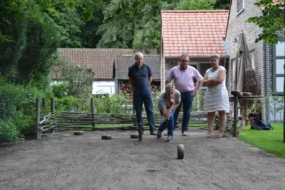 a group of people playing with balls in a yard at B&B 't Heirweggoed in Assenede