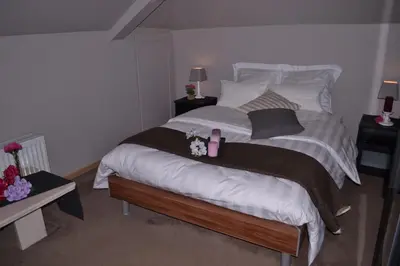 a bedroom with a large bed with two night stands at Hotel Het Gasthof in Herent