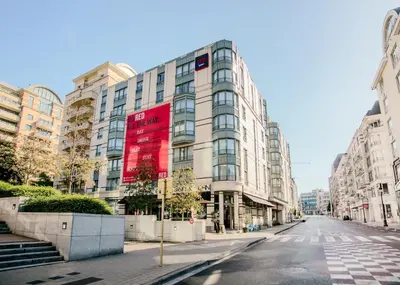 an empty street in front of a large building at Radisson RED Brussels in Brussels