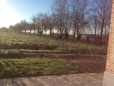a view of a field with trees in the background at Sint-Amands Country Escape in Sint-Amands