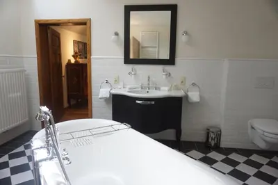 a bathroom with a tub and a sink and a toilet at B&B Domein Rodin in Oud-Turnhout