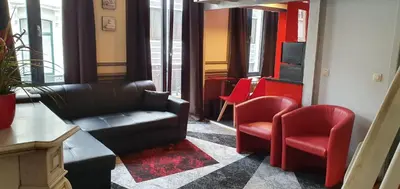 a waiting room with a couch and two chairs at Guesthouse Marie Therese in Brussels