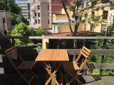 a wooden table and two chairs on a balcony at Guesthouse Marie Therese in Brussels