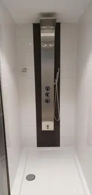 a shower stall with a dispenser in a bathroom at Guesthouse Marie Therese in Brussels