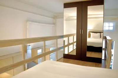 a bedroom with a bed and a mirror at Guesthouse Marie Therese in Brussels