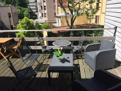 a patio with a table and chairs on a balcony at Guesthouse Marie Therese in Brussels