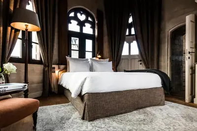 a bedroom with a large bed with large windows at 1898 The Post in Ghent