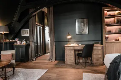 a bedroom with a desk and a bed and a table at 1898 The Post in Ghent